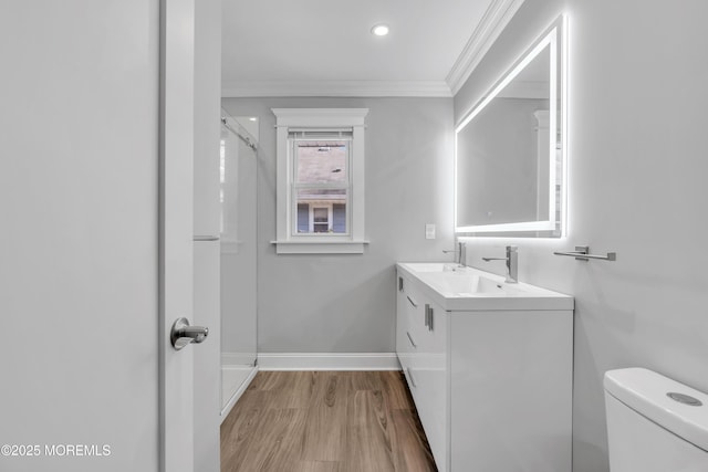 full bathroom featuring wood finished floors, baseboards, a shower, crown molding, and toilet