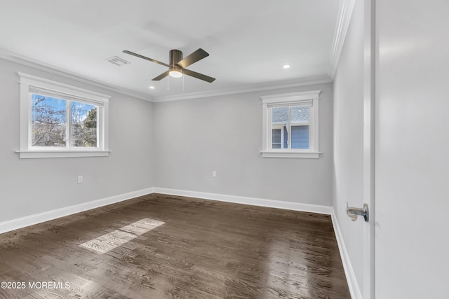 unfurnished room featuring crown molding, baseboards, and wood finished floors