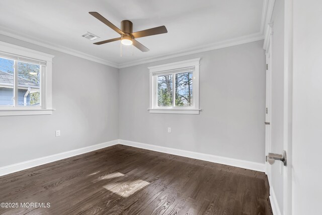 spare room featuring visible vents, a wealth of natural light, and ornamental molding