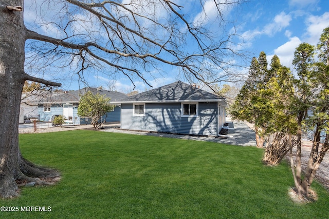 rear view of house with a yard