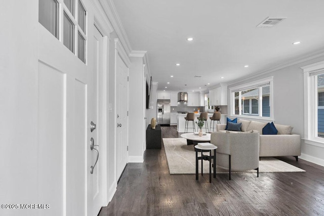 living room featuring dark wood-style floors, visible vents, recessed lighting, and ornamental molding