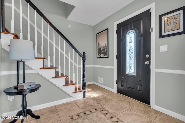 entryway featuring visible vents, baseboards, stairway, and tile patterned flooring