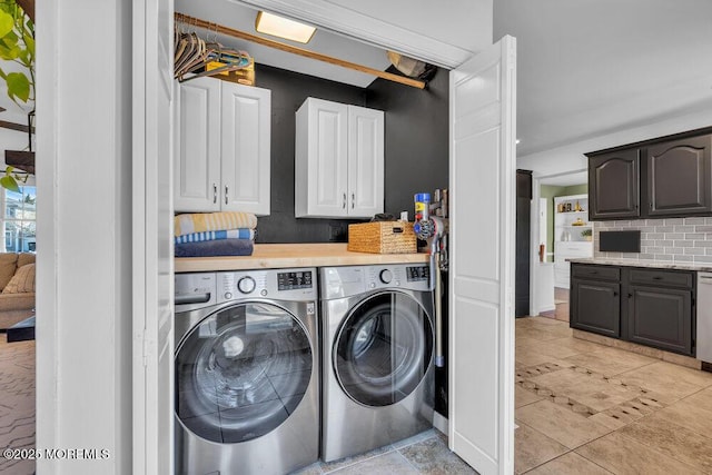 laundry room featuring washer and dryer and cabinet space