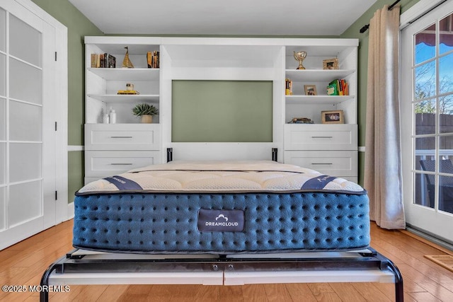 bedroom featuring visible vents and hardwood / wood-style flooring