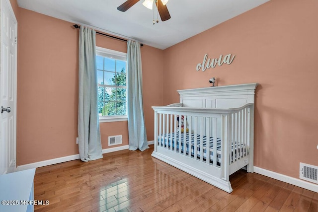 unfurnished bedroom with visible vents, baseboards, and wood finished floors