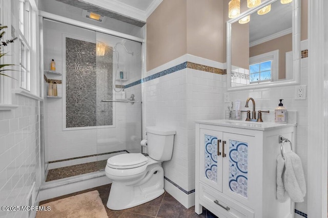 full bath featuring tile walls, a shower stall, toilet, and crown molding