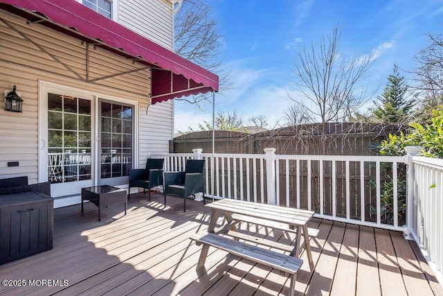 wooden terrace featuring fence