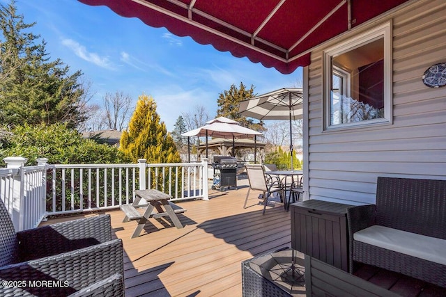 deck featuring grilling area and outdoor dining space