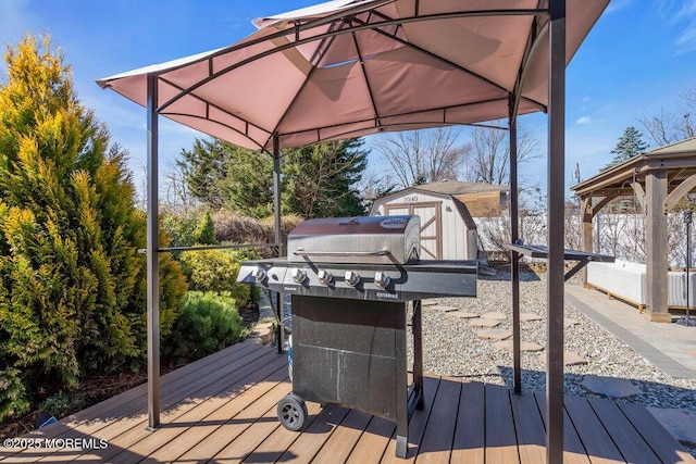 deck with an outbuilding, grilling area, and a storage unit