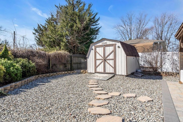 view of shed featuring fence