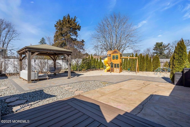 view of patio / terrace with a gazebo, playground community, and fence