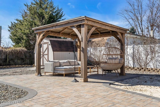 view of patio with a storage shed, a fenced backyard, an outdoor living space, and an outdoor structure