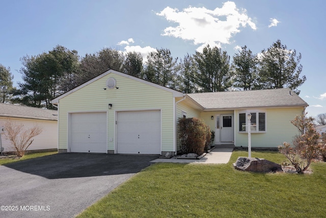 ranch-style house with driveway, a front yard, and an attached garage