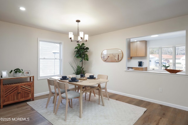 dining area featuring recessed lighting, baseboards, an inviting chandelier, and wood finished floors