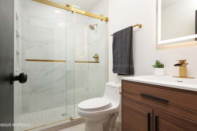 full bathroom featuring a marble finish shower, toilet, and vanity