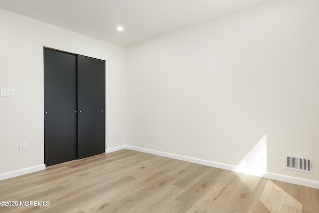 unfurnished bedroom featuring recessed lighting, baseboards, visible vents, and light wood finished floors