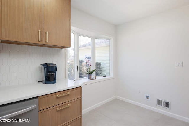 kitchen with visible vents, backsplash, dishwasher, and baseboards