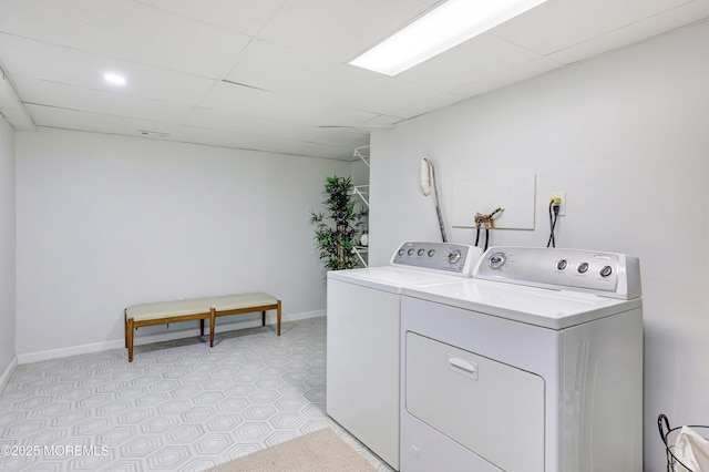 laundry room with washer and dryer, baseboards, and laundry area