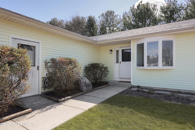 entrance to property with a yard