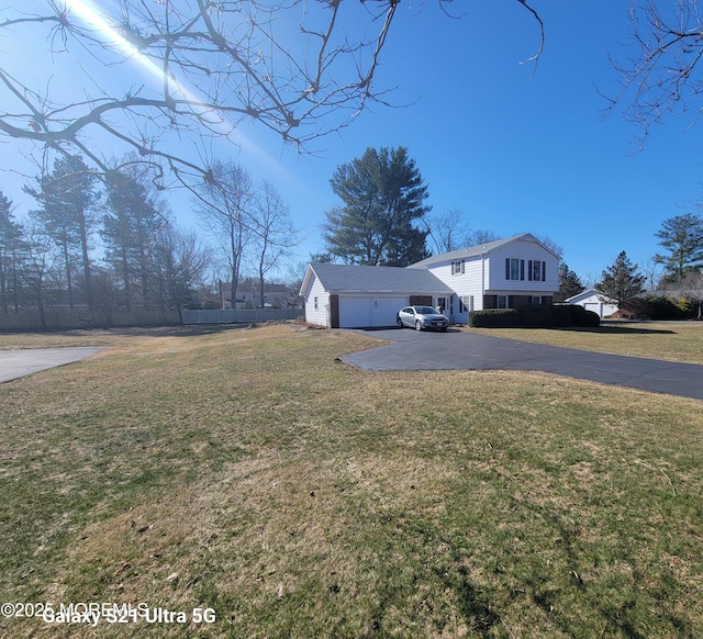 view of front of property with a garage and a front yard