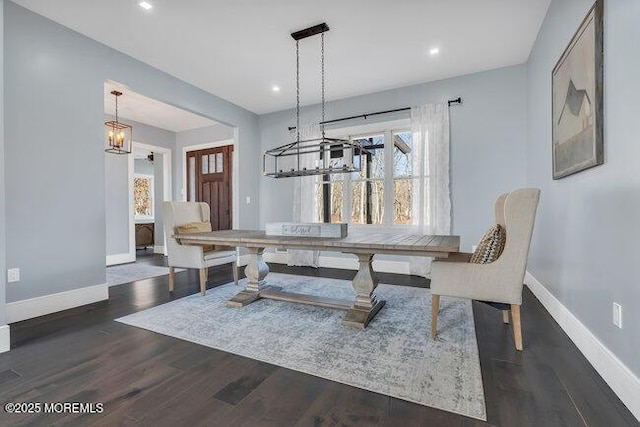 dining room with an inviting chandelier, recessed lighting, wood finished floors, and baseboards