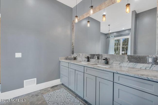 bathroom with visible vents, baseboards, and vanity