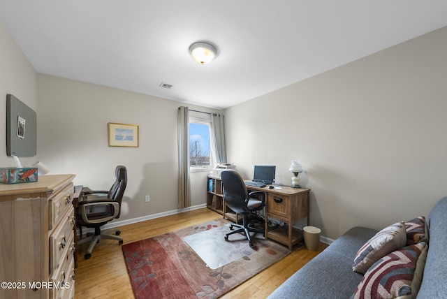 home office featuring visible vents, baseboards, and light wood-type flooring