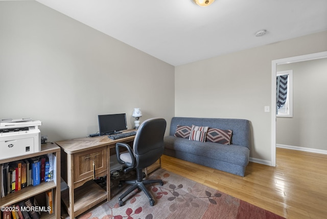 office area with baseboards and wood finished floors