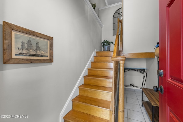 stairway featuring tile patterned flooring and baseboards