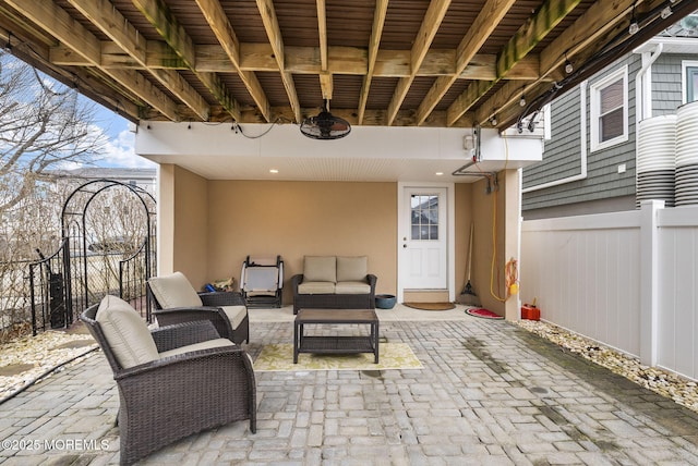 view of patio / terrace with an outdoor living space and fence