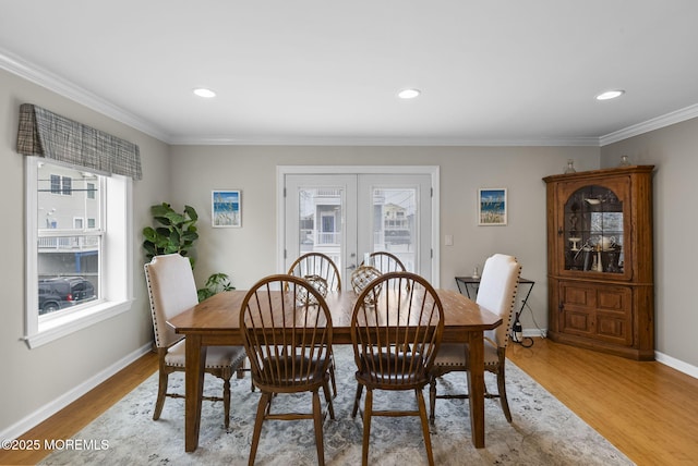 dining room featuring recessed lighting, french doors, crown molding, light wood finished floors, and baseboards