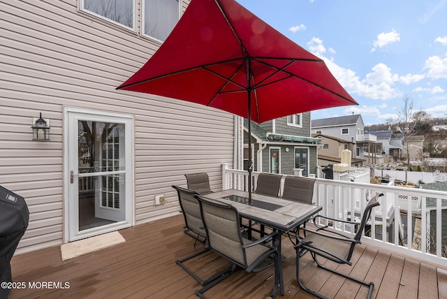 deck with outdoor dining area and a grill