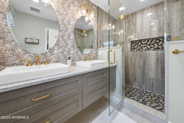 full bath with tile patterned flooring, a walk in shower, visible vents, and a sink