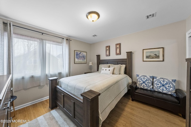 bedroom with visible vents, baseboards, and light wood-style flooring