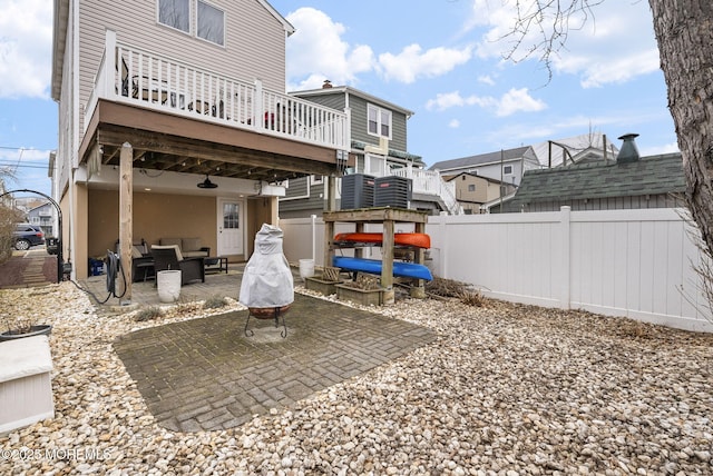 exterior space featuring a deck, a patio, fence, and an outdoor living space