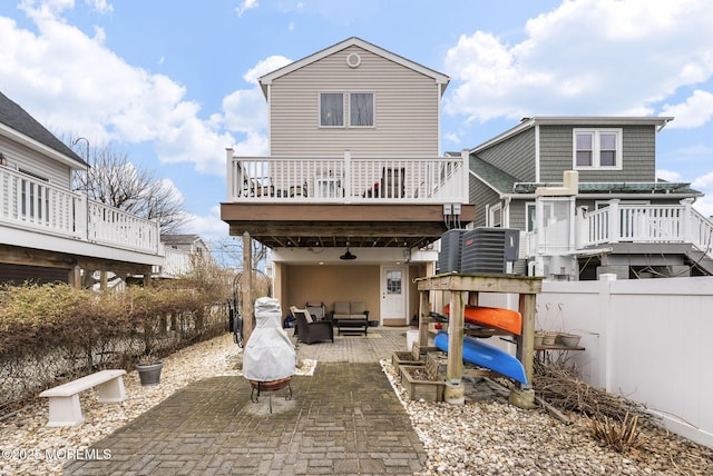 back of house with a patio, a deck, and fence