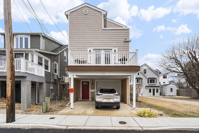 view of front of home with a carport, an attached garage, and concrete driveway