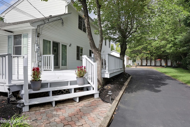 view of property exterior featuring a deck