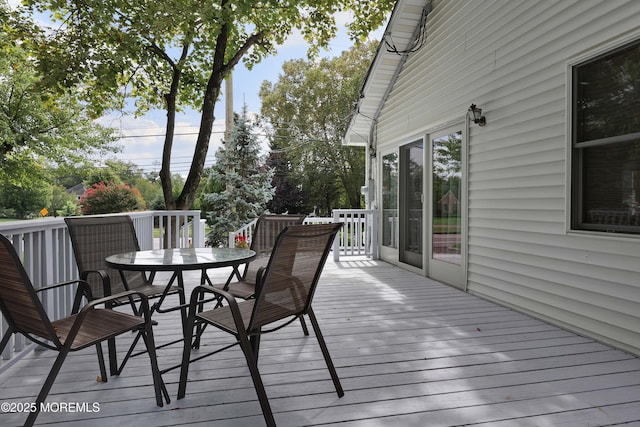 wooden deck featuring outdoor dining area