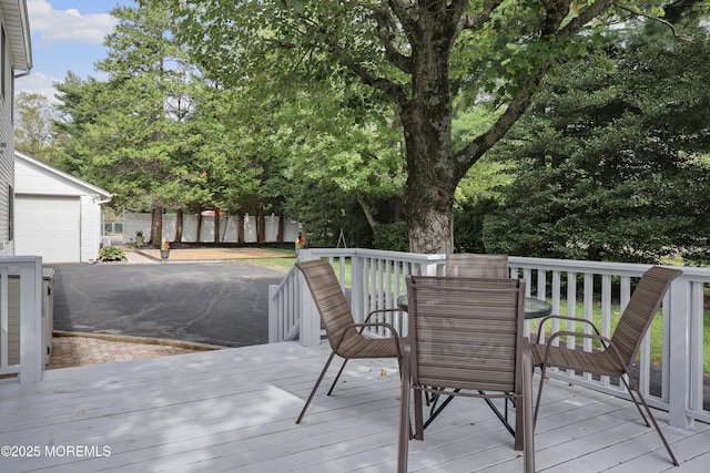 wooden deck with outdoor dining area and fence