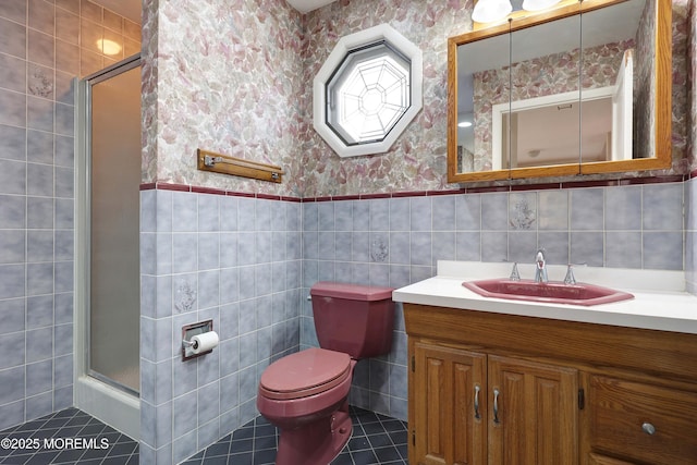 full bathroom featuring a wainscoted wall, a shower stall, wallpapered walls, and toilet