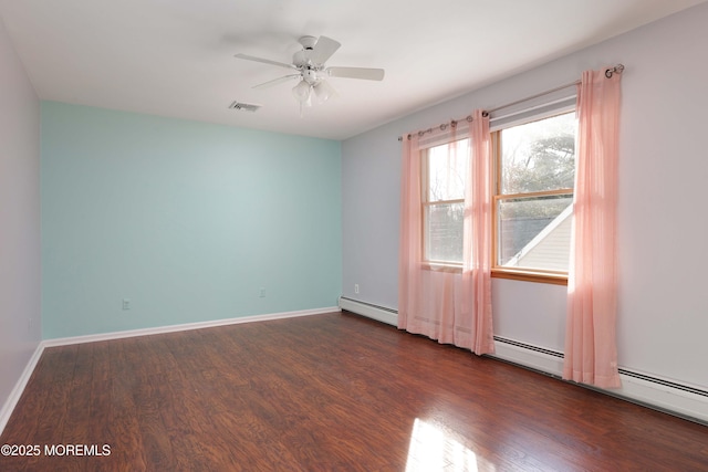 empty room with visible vents, ceiling fan, baseboards, and wood finished floors