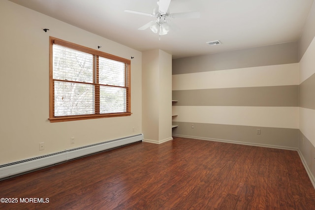 empty room with a ceiling fan, wood finished floors, visible vents, baseboards, and a baseboard heating unit