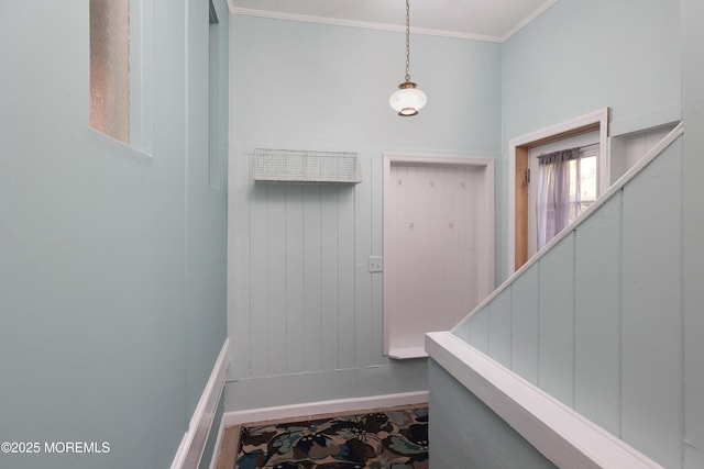 interior space with stairs and ornamental molding