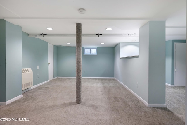 basement with heating unit, carpet flooring, and baseboards