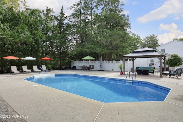 view of pool featuring a gazebo, a patio area, a fenced in pool, and fence