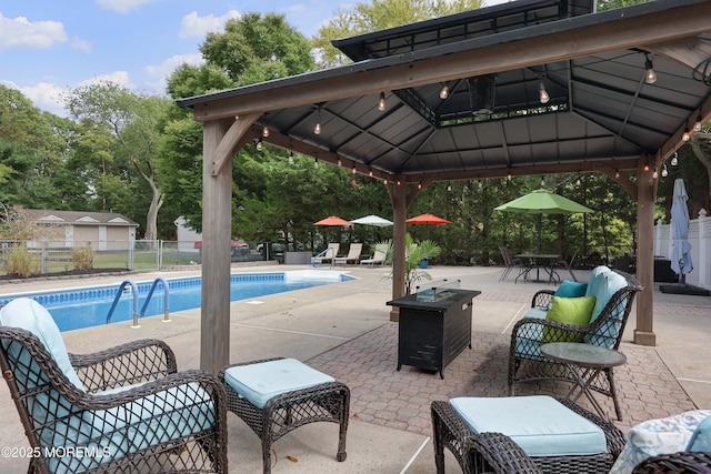 view of swimming pool with a gazebo, a fenced in pool, a patio, and fence