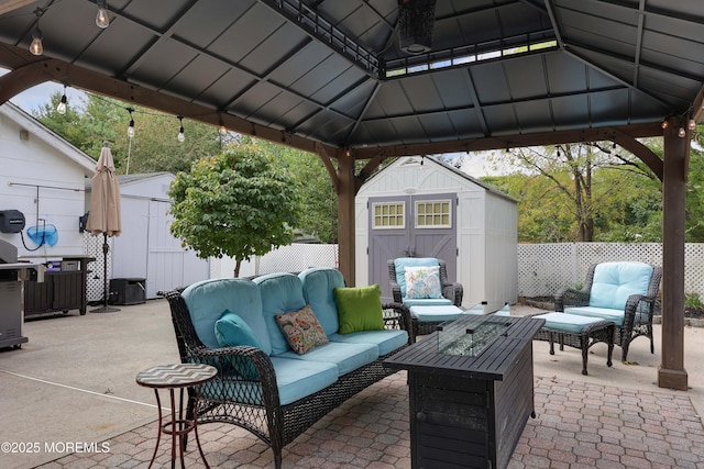 view of patio featuring a gazebo, a storage shed, fence, and an outdoor hangout area