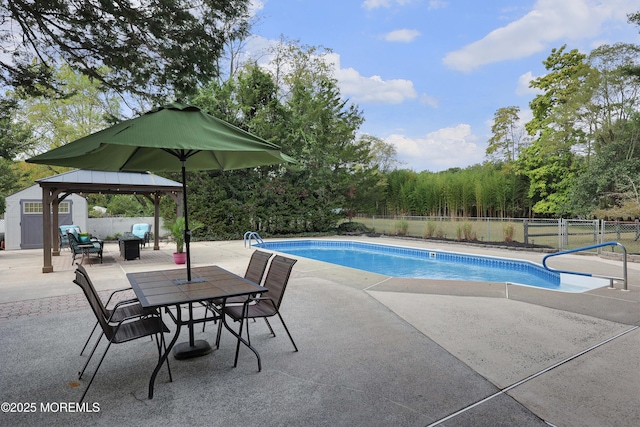 view of swimming pool featuring a gazebo, a fenced in pool, a patio area, and fence