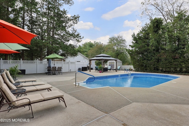 view of pool with a gazebo, a patio area, a fenced in pool, and fence